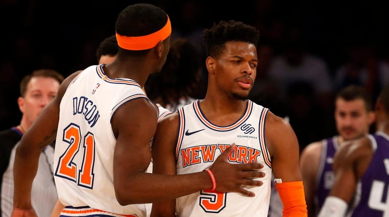 Dennis Smith Jr. of the Knicks reacts with teammate Damyean Dotson after...