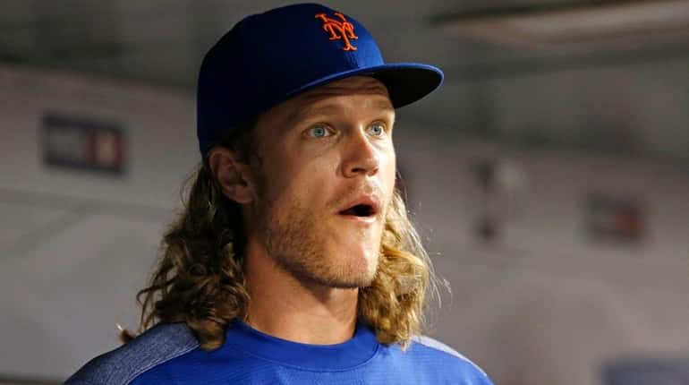 Mets pitcher Noah Syndergaard looks on during a game against...