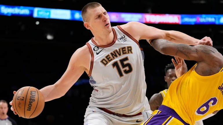 Denver Nuggets center Nikola Jokic collides with Los Angeles Lakers...