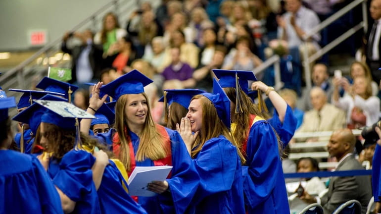 Students celebrate their graduation at the 2014 commencement at Hofstra...
