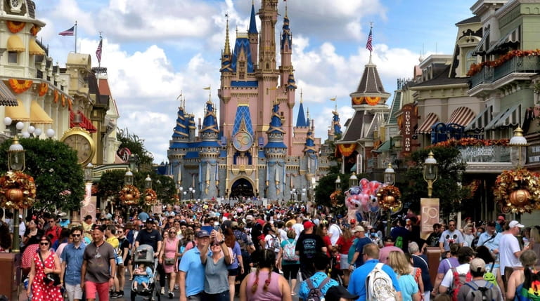 Crowds fill Main Street USA in front of Cinderella Castle...
