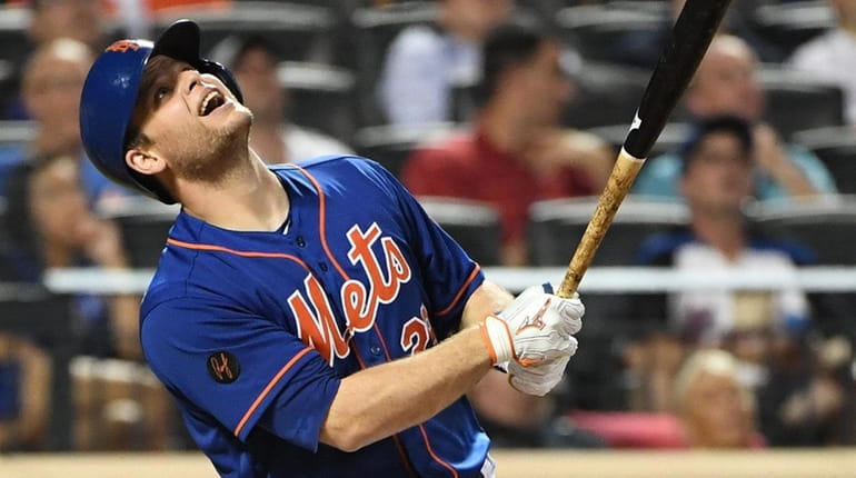 Mets catcher Devin Mesoraco looks up as he fouls out...