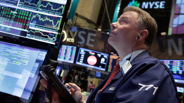 A trader watches the markets climb on Dec. 18, 2014...