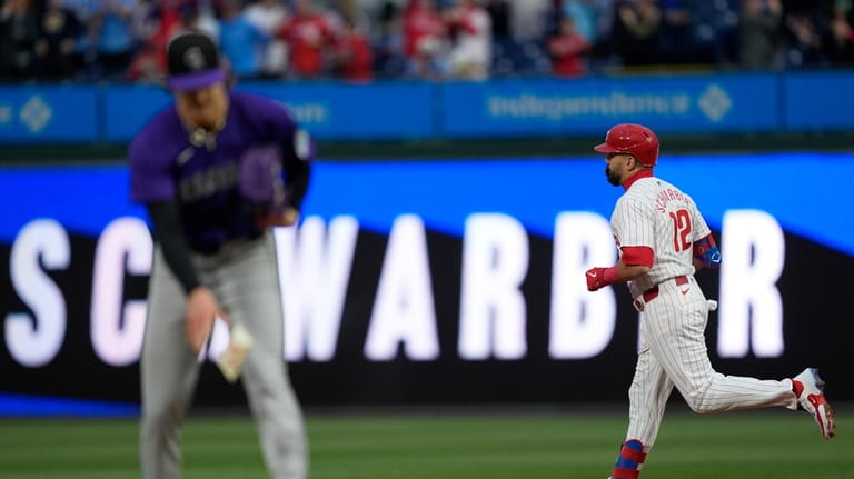 Philadelphia Phillies' Kyle Schwarber runs the basses after hitting a...