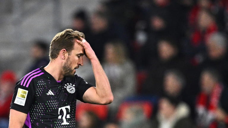Munich's Harry Kane reacts during the Bundesliga soccer match between...