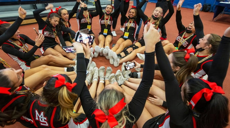 Mt. Sinai cheerleaders react after winning first place in the...
