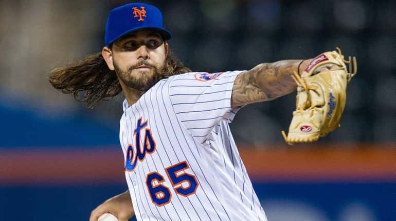 Mets pitcher Robert Gsellman delivers a pitch against the Phillies...