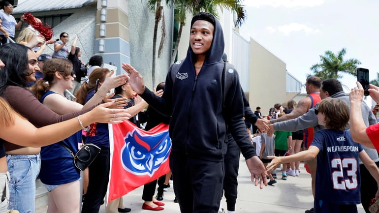 Florida Atlantic guard Brandon Weatherspoon is greeted by supporters Wednesday,...