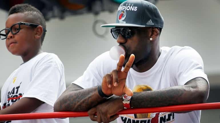 LeBron James of the Miami Heat rides in a victory...