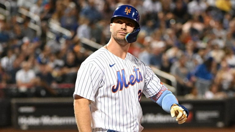 Mets first baseman Pete Alonso looks on after he lined...