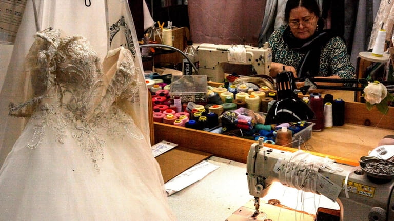 Seamstresses are backloged with work at Bridal Reflections Bridal Salon in...