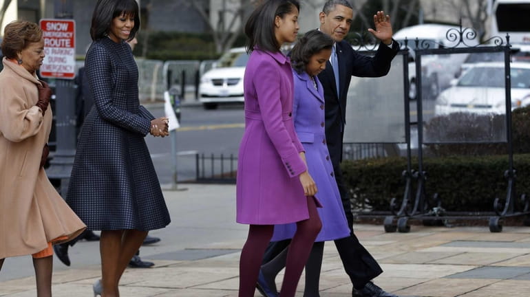 President Barack Obama, accompanied by his daughters Sasha and Malia,...