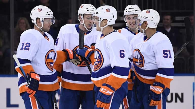 Islanders players after a goal by Ryan Pulock against the...
