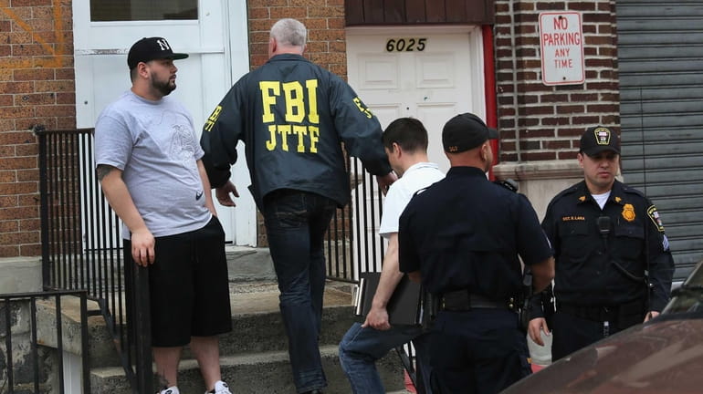 FBI agent enters the apartment building door of Alina Tsarnaeva...
