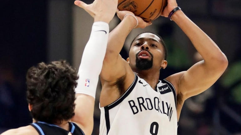 The Nets' Spencer Dinwiddie shoots over the Cavaliers' Cedi Osman...