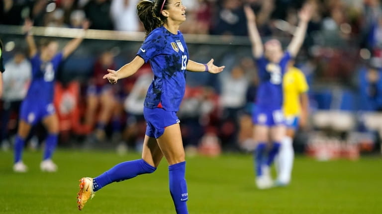United States forward Alex Morgan (13) reacts to scoring a...