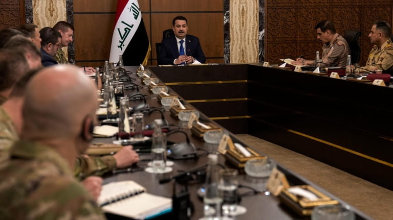 Iraqi Prime Minister Mohammed Shia al Sudani, center, chairs the...