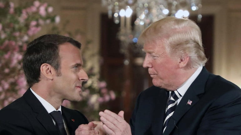 President Donald Trump and French President Emmanuel Macron hold a...