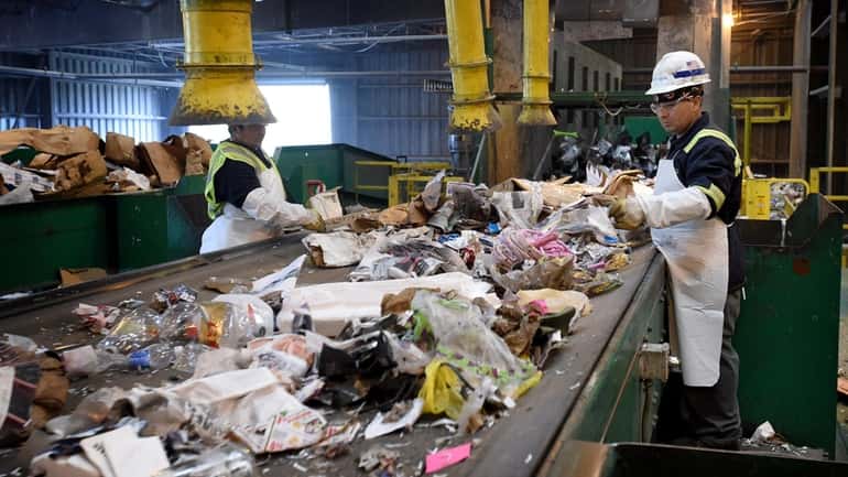 Workers at Green Stream Recycling presort material at their Brookhaven...