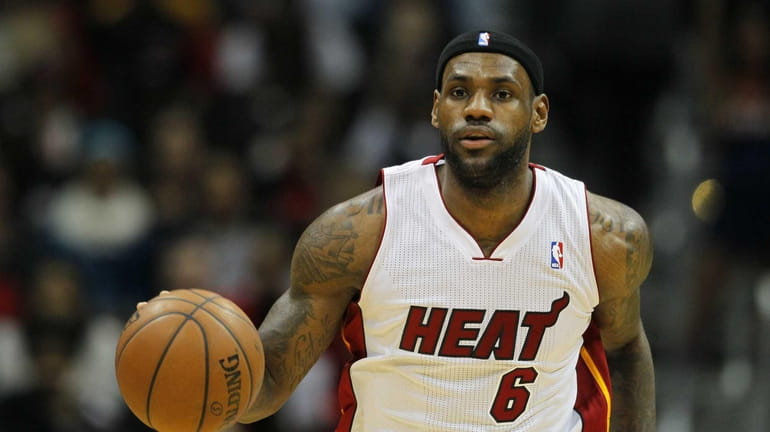 Miami Heat small forward LeBron James (6) drives down the...