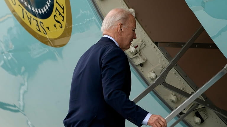 President Joe Biden boards Air Force One at Los Angeles...