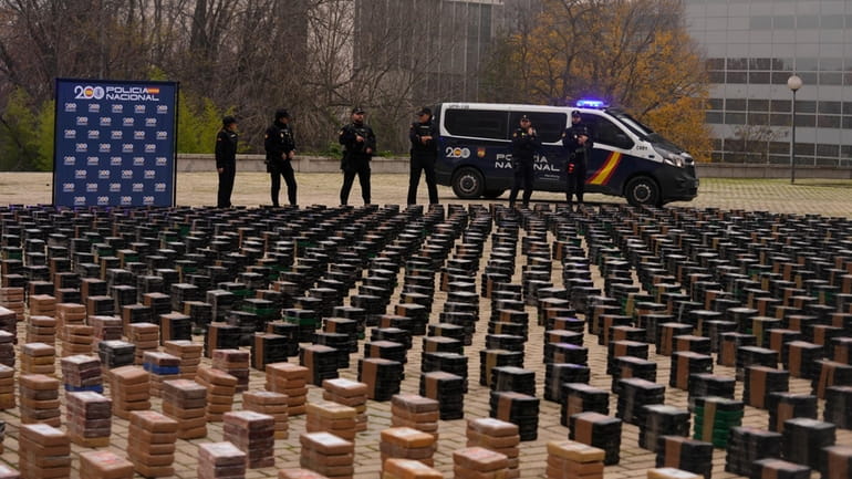Police officers stand by part of a haul of 11...