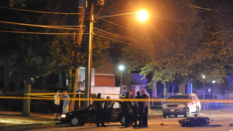 Nassau County police investigate the scene of a crash involving...