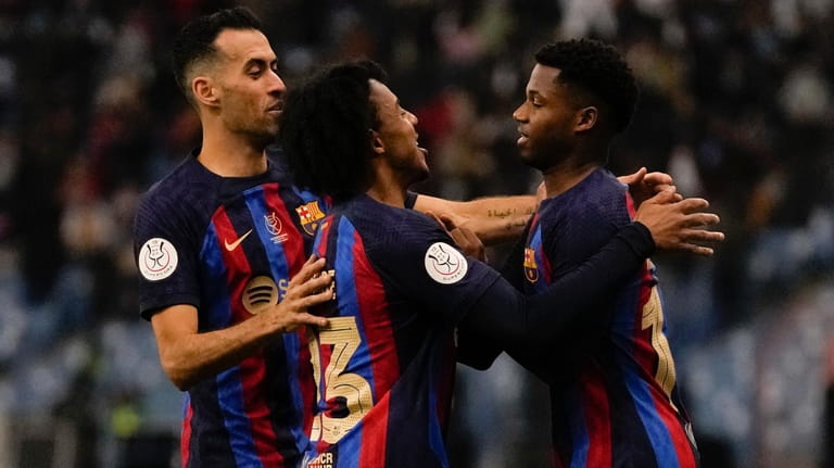 Barcelona's players celebrate after a goal during a semi-final of...