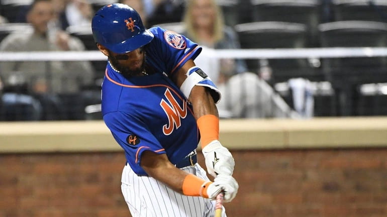Mets shortstop Amed Rosario hits an RBI single against the...