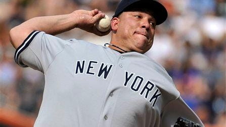 Yankees starting pitcher Bartolo Colon throws against the Mets during...