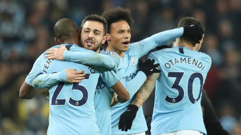 Manchester City's Leroy Sane, second right, celebrates with teammates after...