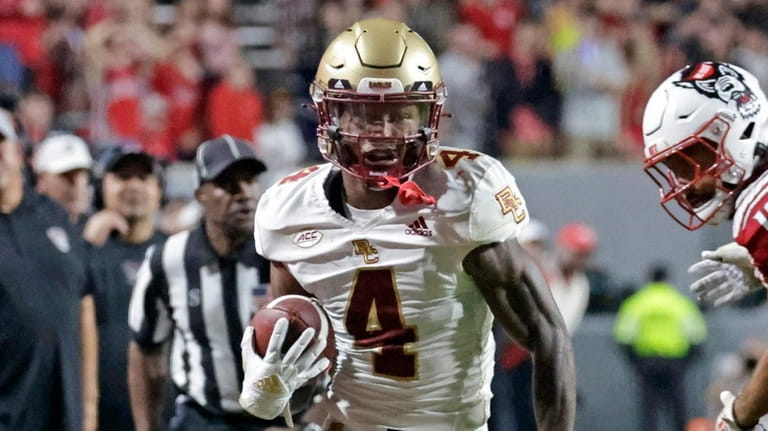 Boston College wide receiver Zay Flowers gets past North Carolina State...