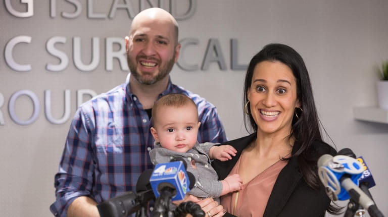 Christina and Franco DiMartino of Massapequa, with their 9-month-old son,...