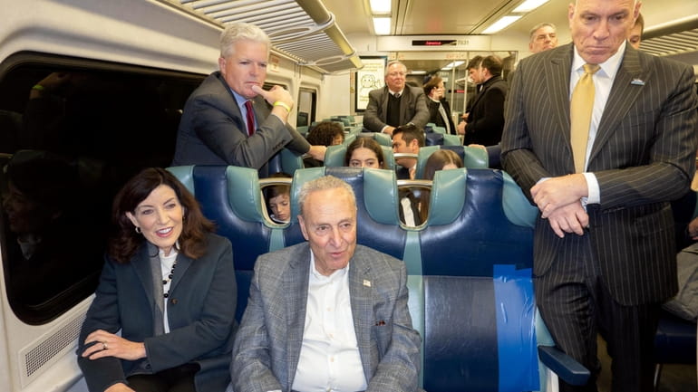 Gov. Kathy Hochul and Sen. Chuck Schumer, front, sitting, Suffolk County Executive...