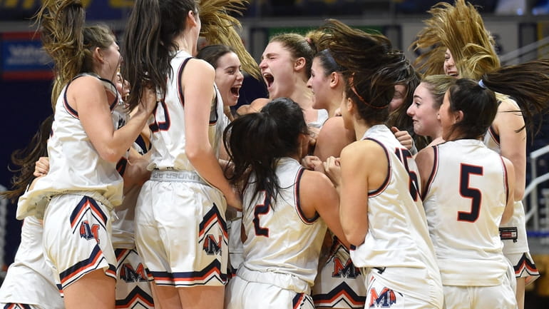 Manhasset teammates celebrate after their 41-39 win over Bethpage in...
