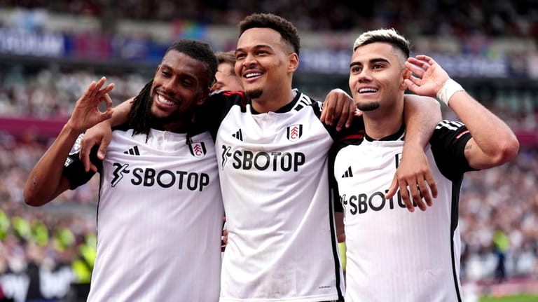 Fulham's Andreas Pereira, right, celebrates with team-mates Rodrigo Muniz and...