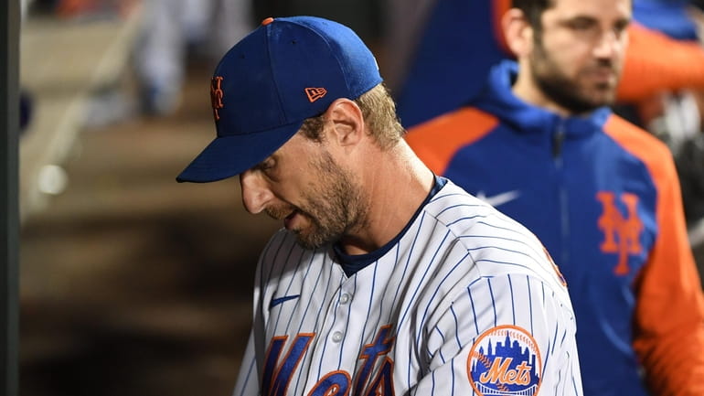 New York Mets starting pitcher Max Scherzer walks through the...