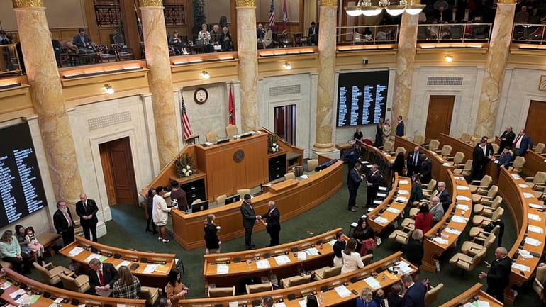 Arkansas lawmakers gather in the House of Representatives chamber at...