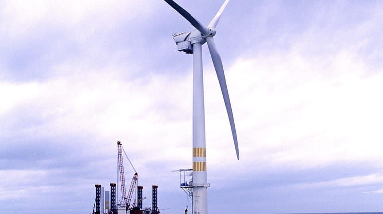 A wind turbine generates power off the coast of Southern...