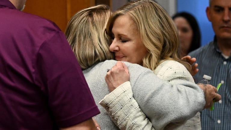 Oakland County prosecutor Karen McDonald, right, hugs Nicole Beausoleil, mother...