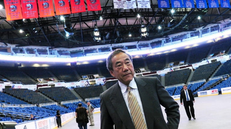 Charles Wang walks through Nassau Coliseum after addressing media and...