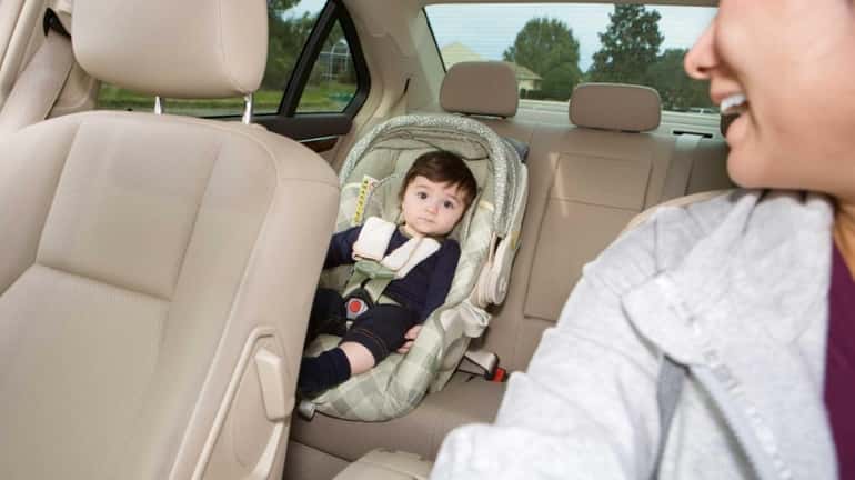 Baby in car seat while his mom is driving.