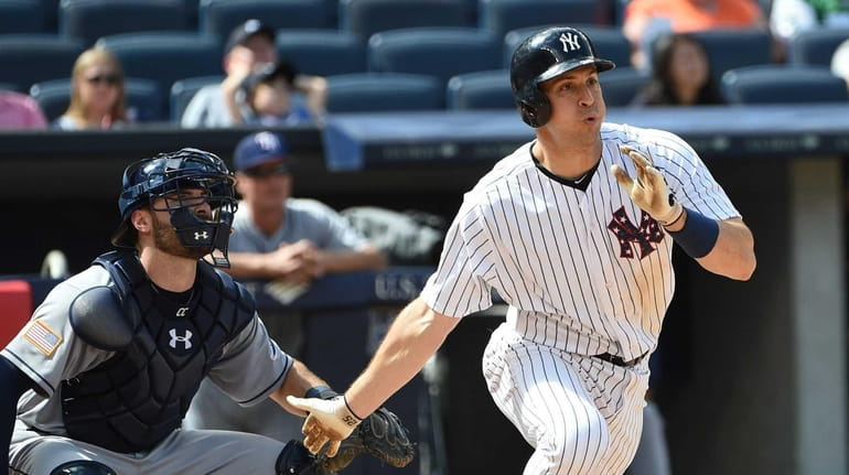 New York Yankees first baseman Mark Teixeira doubles to right...