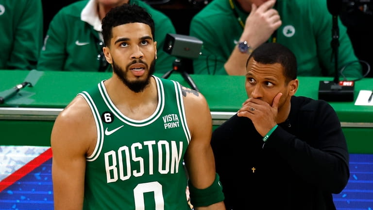 Boston Celtics head coach Joe Mazzulla, right, talks with forward...