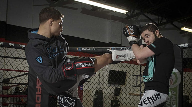 UFC fighter Al Iaquinta of Wantagh, left, trains with Justin...