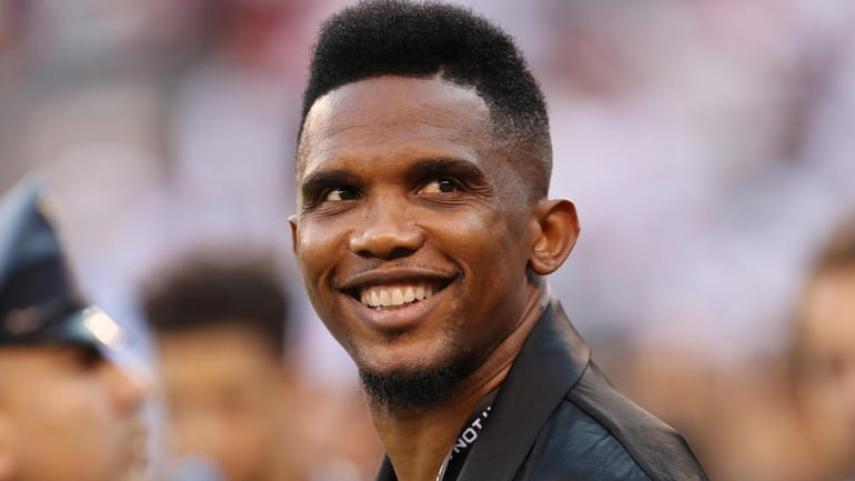 FILE - Soccer player Samuel Eto'o watches warmups before an...