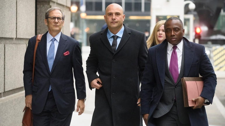 Craig Carton, center, arrives at a federal courthouse in lower...