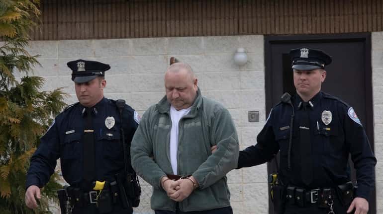 Robert Weis, a Suffolk correction officer, is escorted out of Southhampton...