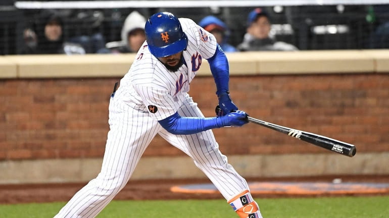 Mets pinch hitter Jose Reyes strikes out swinging against the...