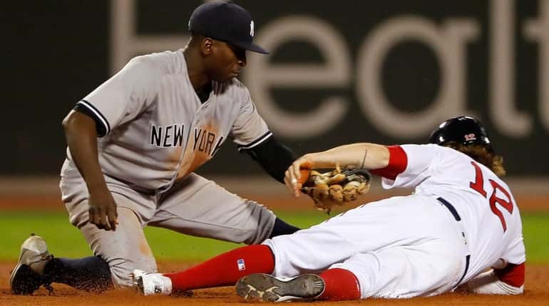 Yankees shortstop Didi Gregorius tags out the Red Sox's Brock...